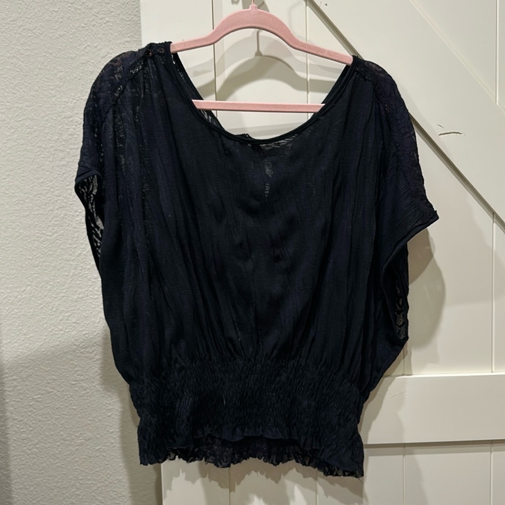 Free People black blouse with tie in back. Elastic waist. Somewhat sheer